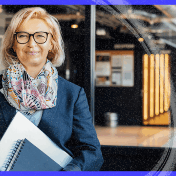A professional woman holding notebooks in a modern office environment, representing marketing automation strategy for a Polish publishing house.