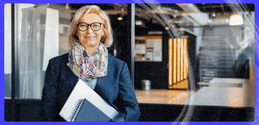 A professional woman holding notebooks in a modern office environment, representing marketing automation strategy for a Polish publishing house.